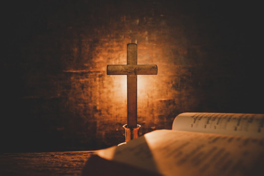 Open Holy Bible and candle on a old oak wooden table. Beautiful